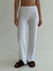 Set of long-sleeved shirts with buttons and ribbed pants, small pink flower on white