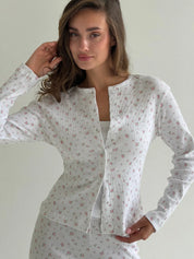 Set of long-sleeved shirts with buttons and ribbed pants, small pink flower on white