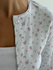 Set of long-sleeved shirts with buttons and ribbed pants, small pink flower on white