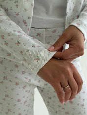Set of long-sleeved shirts with buttons and ribbed pants, small pink flower on white