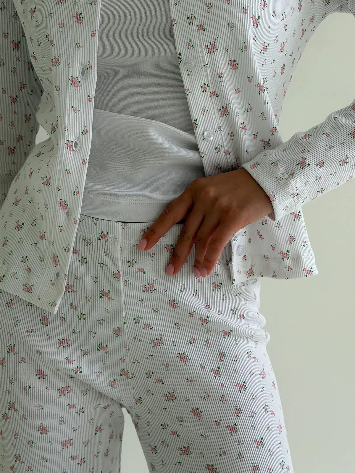 Set of long-sleeved shirts with buttons and ribbed pants, small pink flower on white
