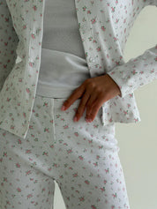 Set of long-sleeved shirts with buttons and ribbed pants, small pink flower on white