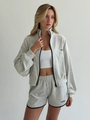 Velour sports suit with zip-up jacket and striped shorts, milk melange