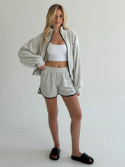 Velour sports suit with zip-up jacket and striped shorts, milk melange