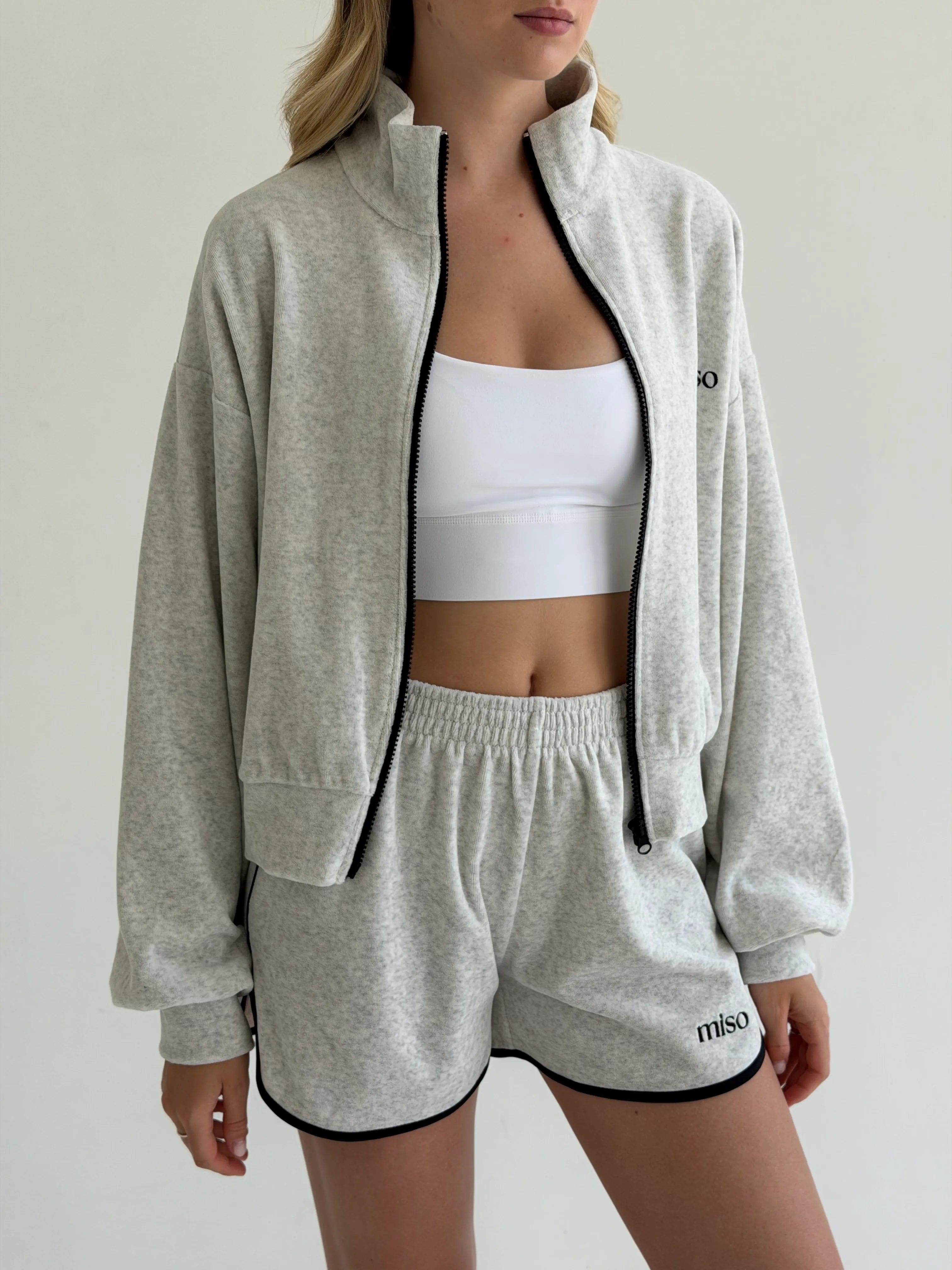 Velour sports suit with zip-up jacket and striped shorts, milk melange