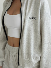 Velour sports suit with zip-up jacket and striped shorts, milk melange