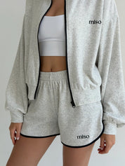 Velour sports suit with zip-up jacket and striped shorts, milk melange