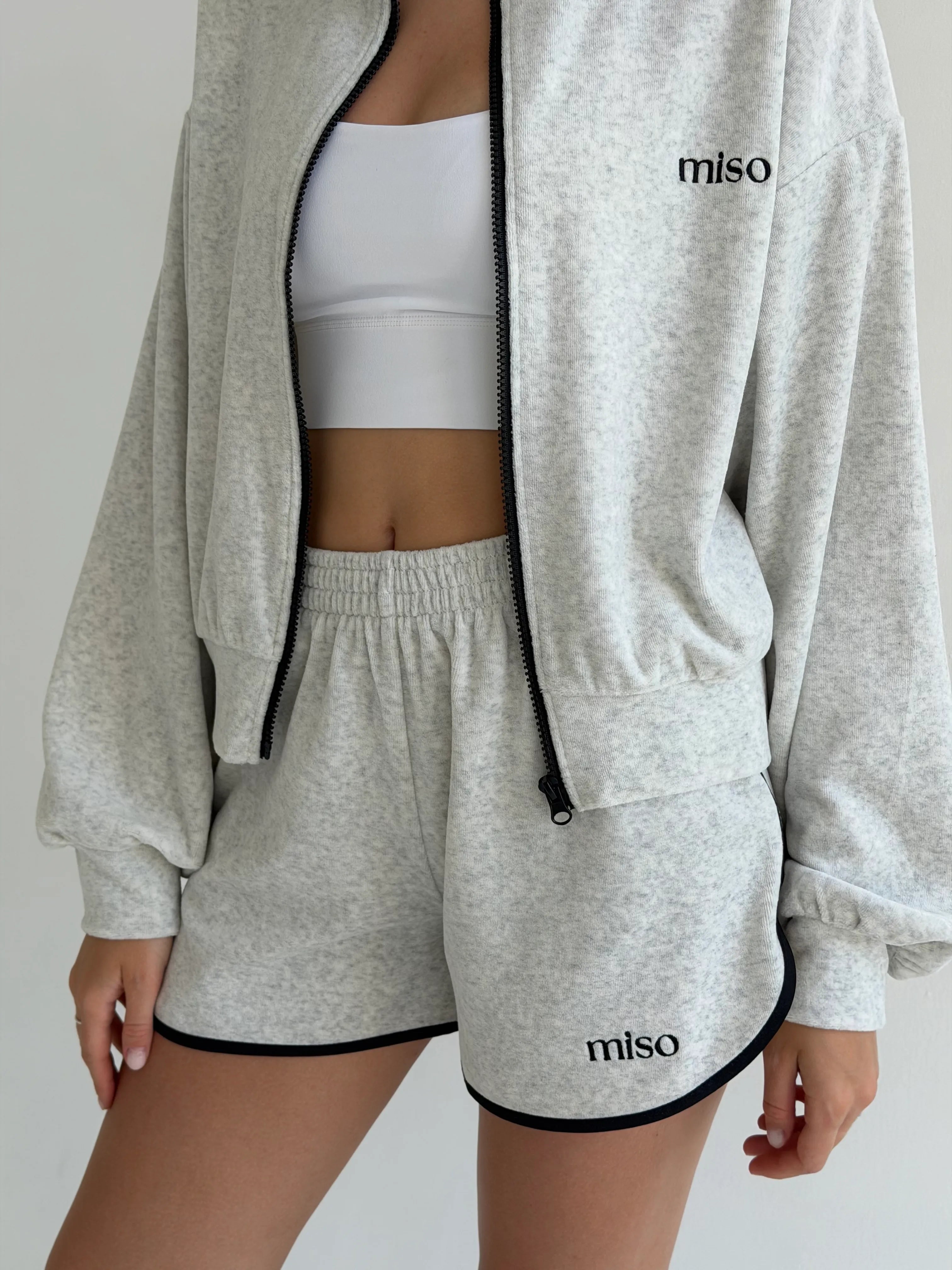 Velour sports suit with zip-up jacket and striped shorts, milk melange