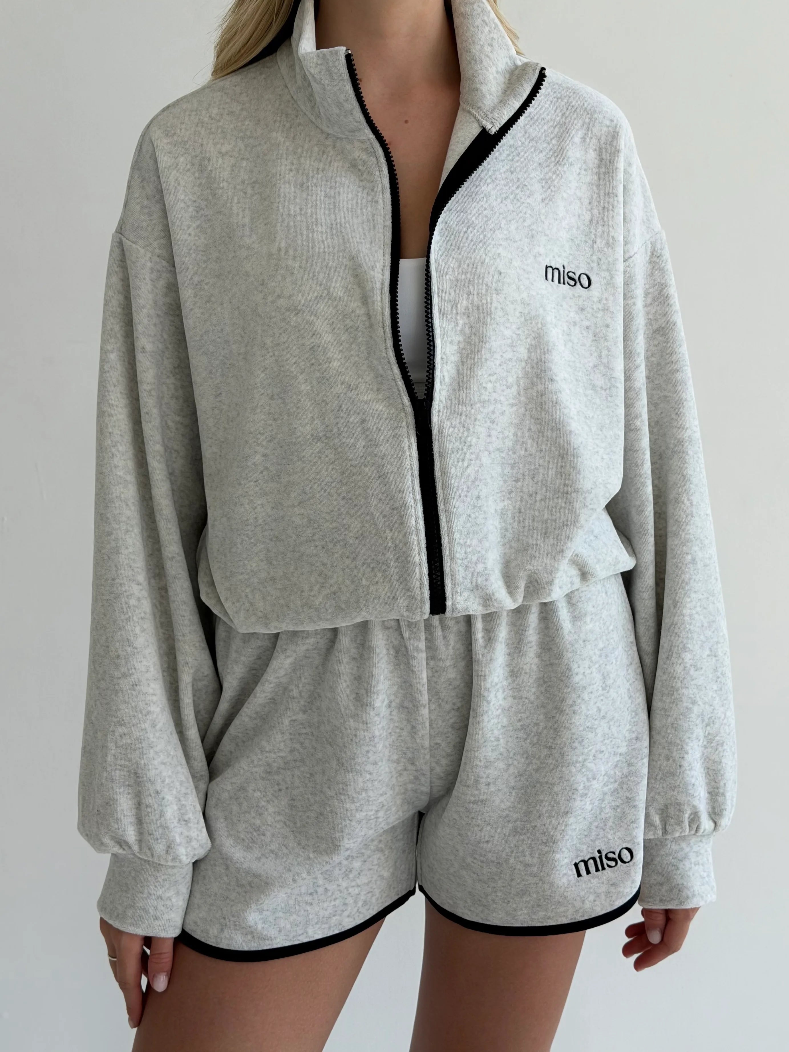 Velour sports suit with zip-up jacket and striped shorts, milk melange