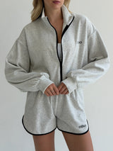 Velour sports suit with zip-up jacket and striped shorts, milk melange
