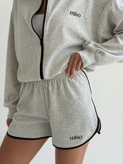 Velour sports suit with zip-up jacket and striped shorts, milk melange