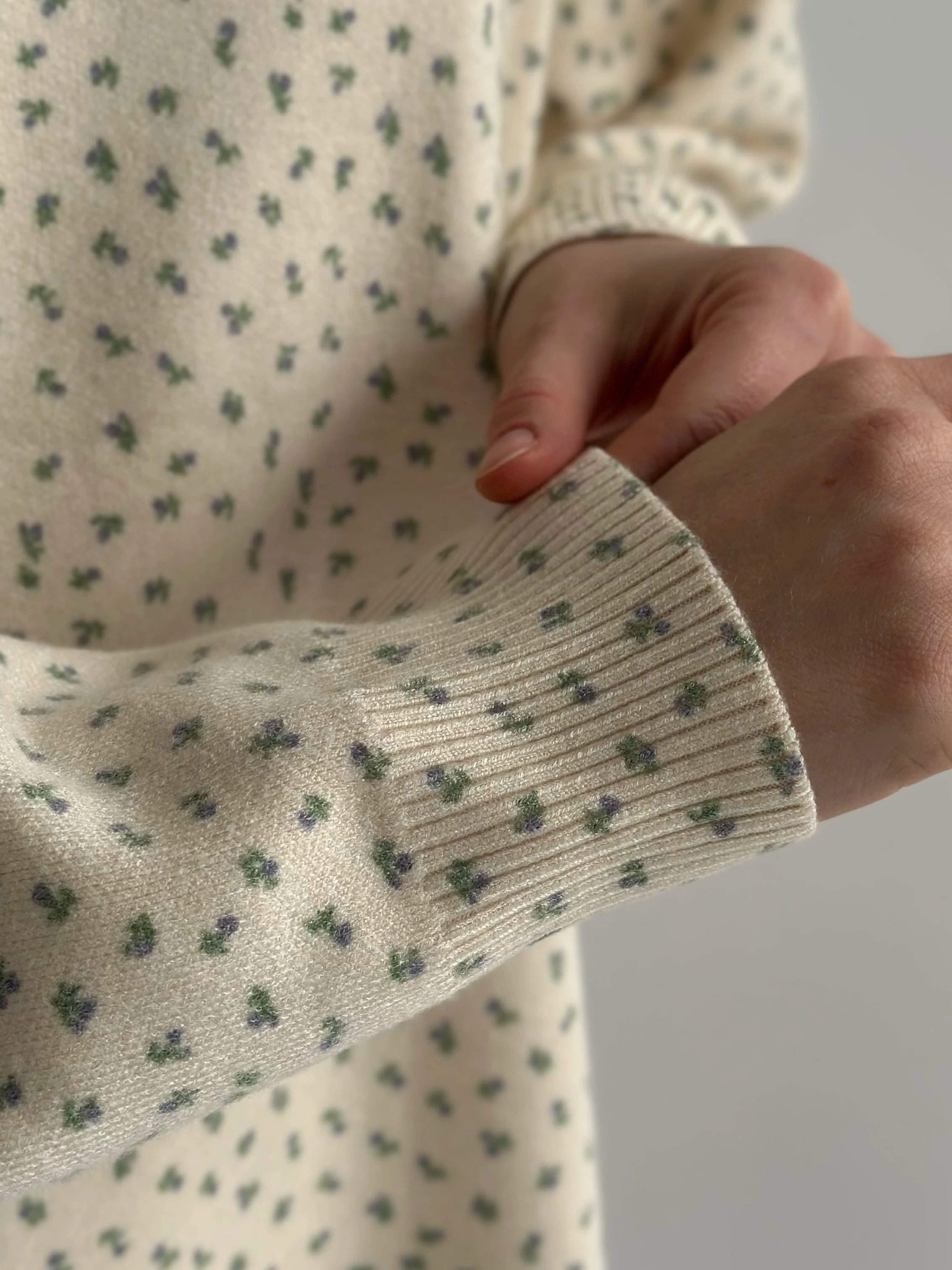 Knitted milky sweater with a blue flower