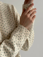 Knitted milky sweater with a blue flower