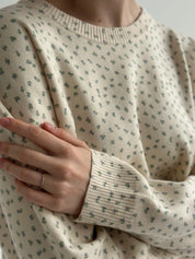 Knitted milky sweater with a blue flower