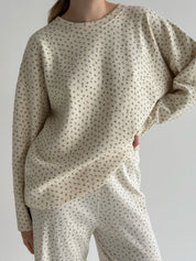 Knitted milky sweater with a blue flower