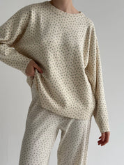 Knitted milky sweater with a blue flower