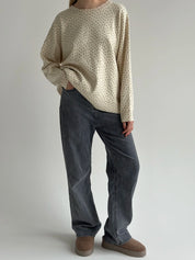 Knitted milky sweater with a blue flower