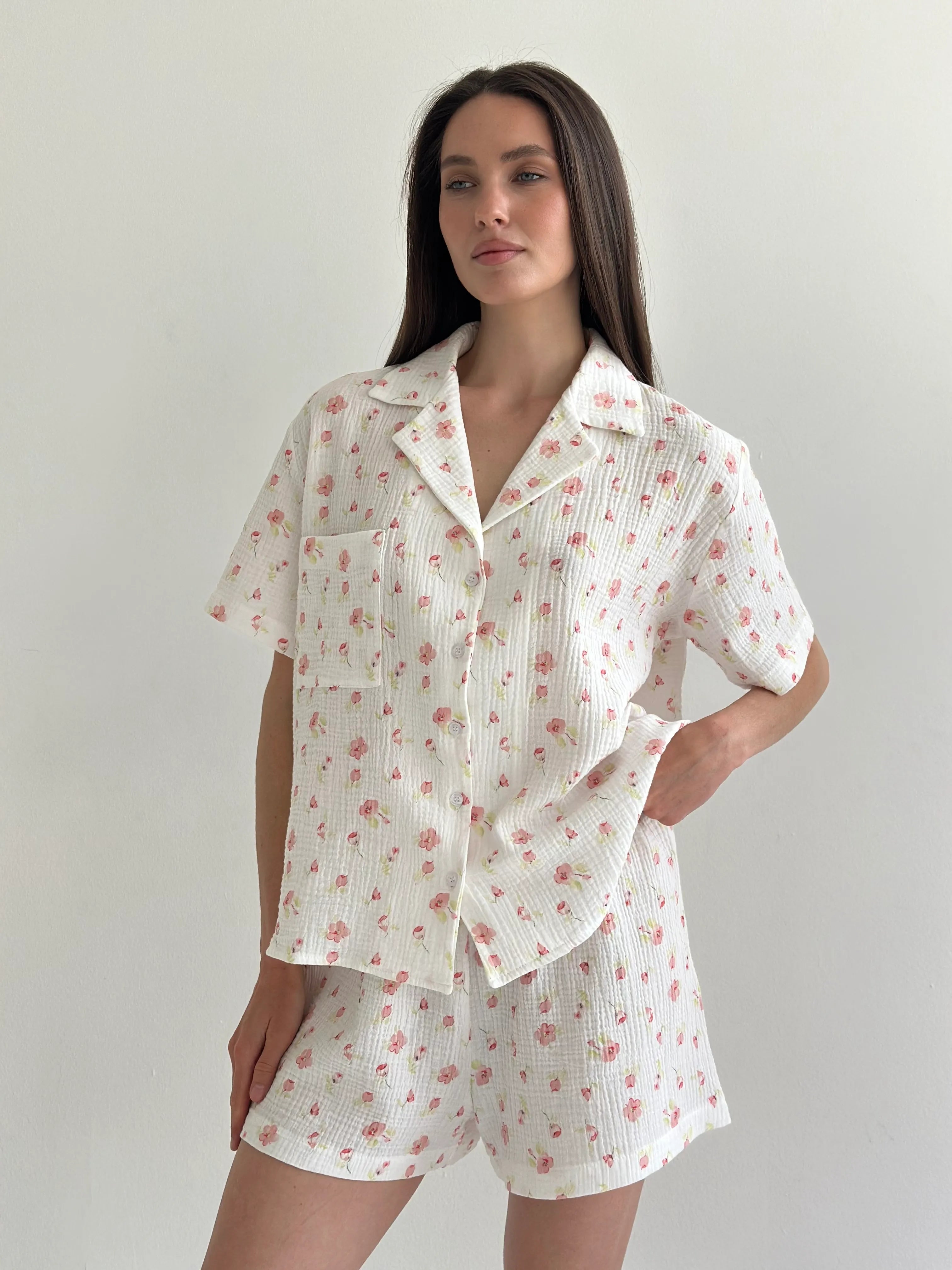 Shorts and short-sleeved muslin flower shirt suit on white