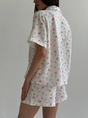 Shorts and short-sleeved muslin flower shirt suit on white