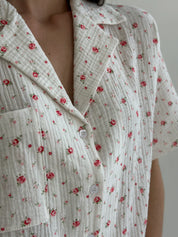 Shorts and short-sleeved muslin flower shirt suit on white