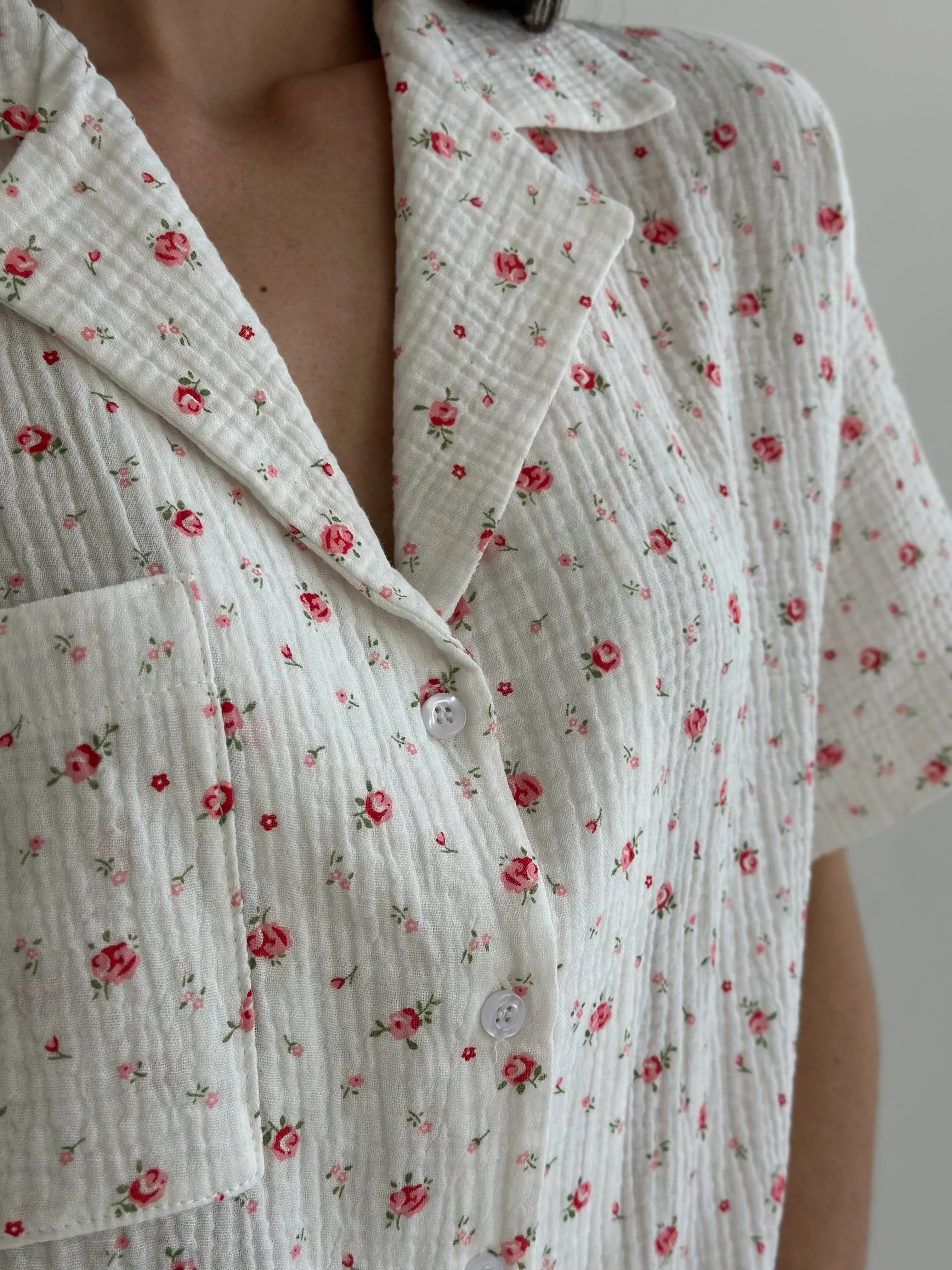 Shorts and short-sleeved muslin flower shirt suit on white