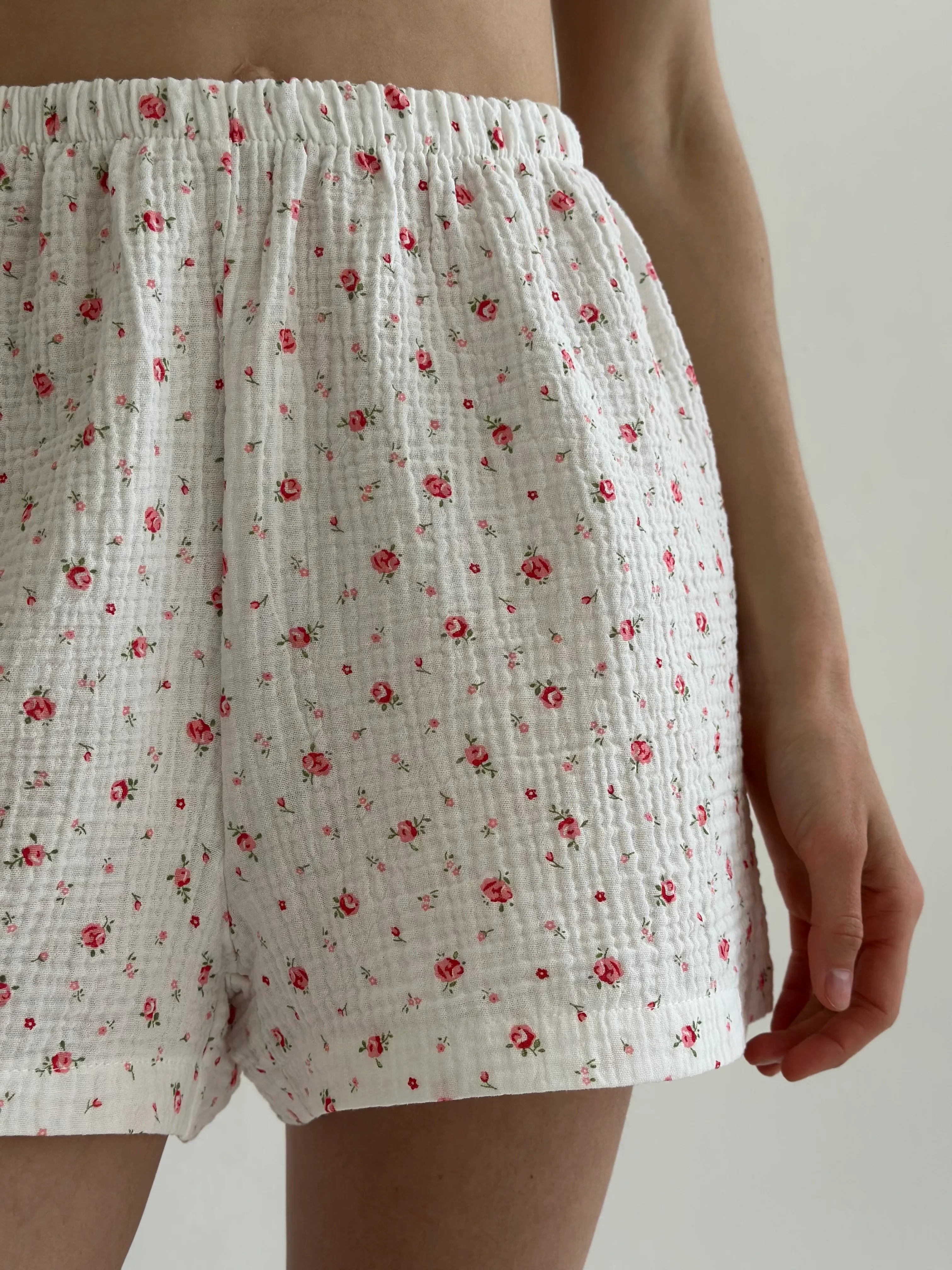 Shorts and short-sleeved muslin flower shirt suit on white