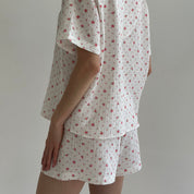 Shorts and short-sleeved muslin flower shirt suit on white