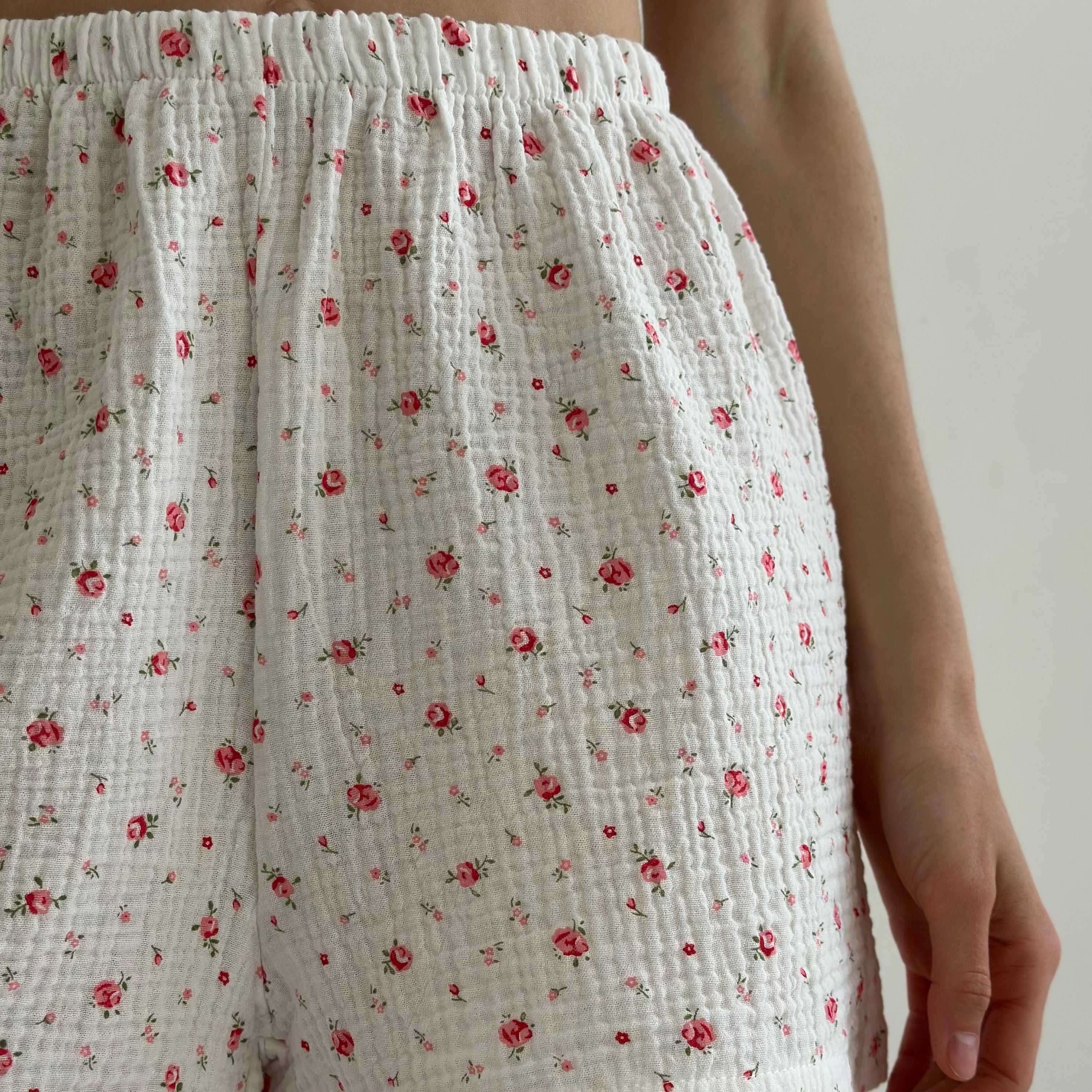 Shorts and short-sleeved muslin flower shirt suit on white