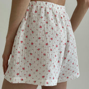 Shorts and short-sleeved muslin flower shirt suit on white