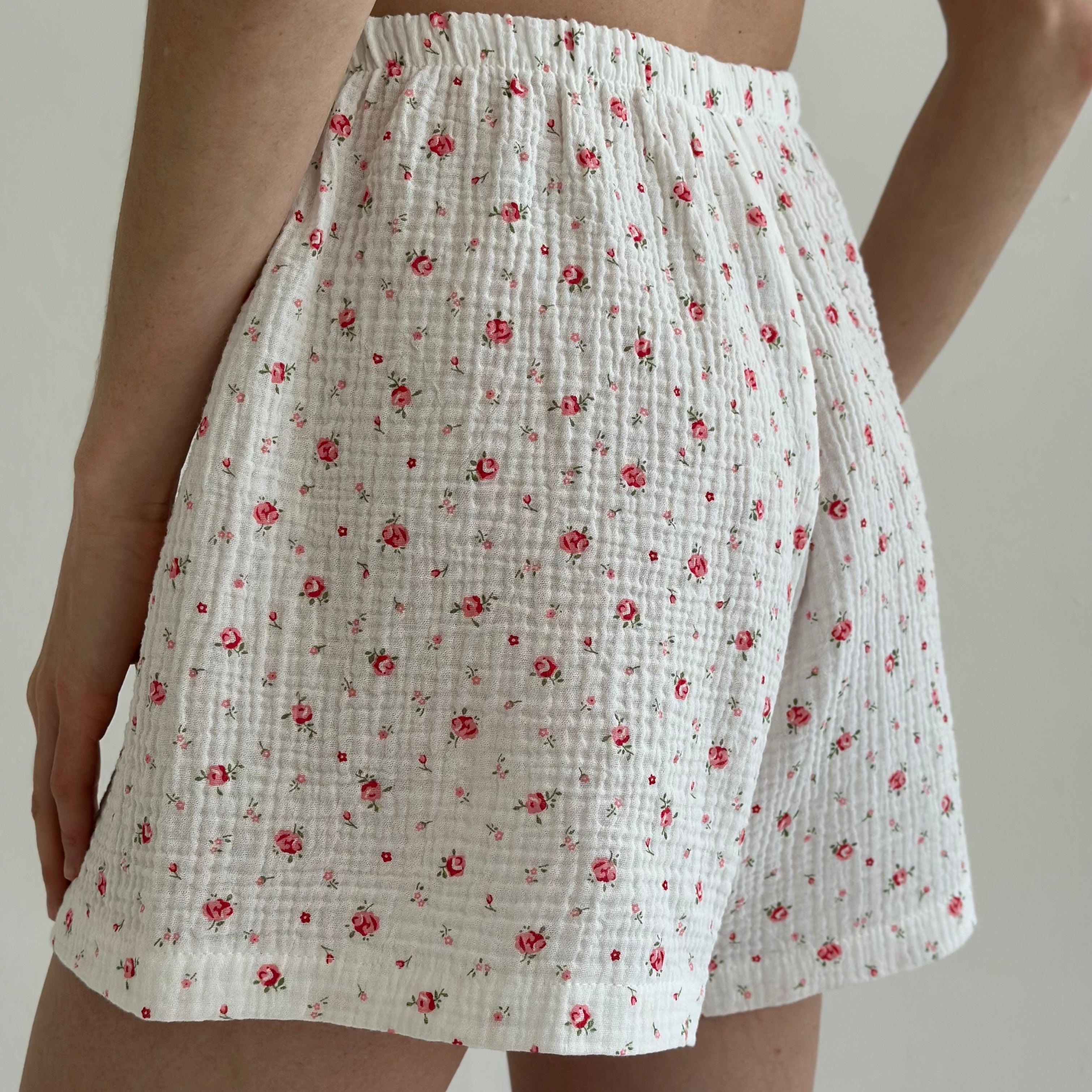 Shorts and short-sleeved muslin flower shirt suit on white
