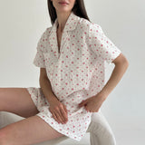 Shorts and short-sleeved muslin flower shirt suit on white