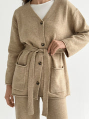 Set knitted cardigan with belt and beige pants
