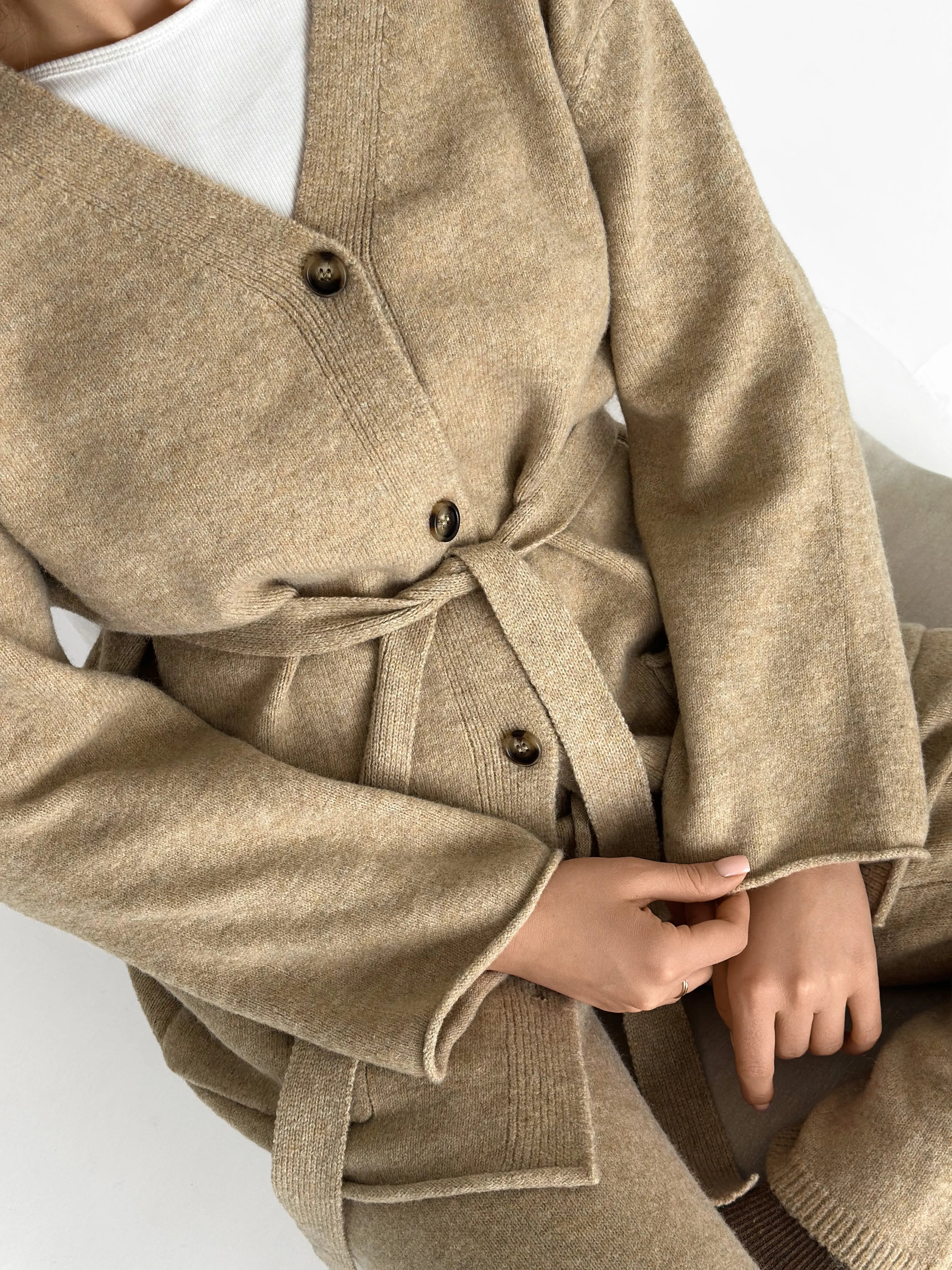 Set knitted cardigan with belt and beige pants